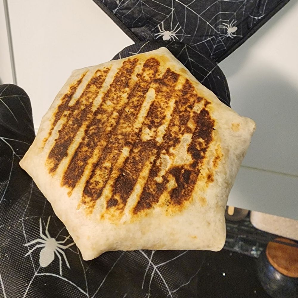 Home-made crunch wrap with gril marks from a bacon press