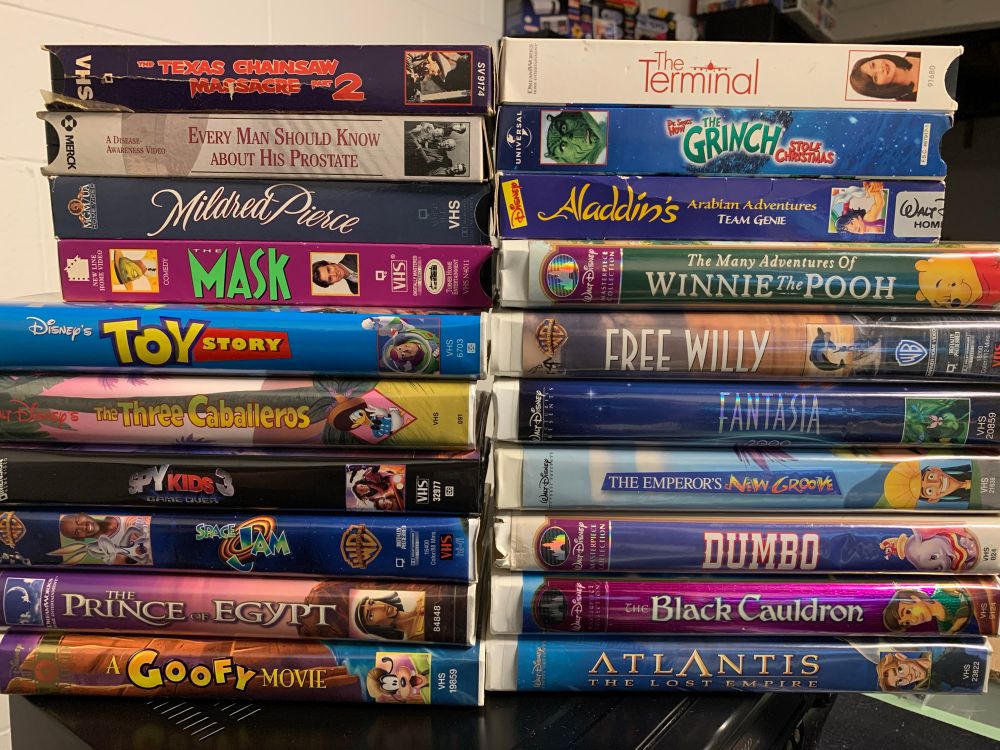 The Texas Chainsaw Massacre Part 2, Every Man Should Know About His Prostate, Mildred Pierce, The Mask, Toy Story, The Three Caballeros, Spy Kids 3, Space Jam, The Prince of Egypt, A Goofy Movie, The Terminal, How The Grinch Stole Christmas, Aladdin's Arabian Adventures, The Many Adventures of Winnie the Pooh, Free Willy, Fantasia 2000, The Emperor's New Groove, Dumbo, The Black Cauldron, and Atlantis The Lost Empire all on VHS