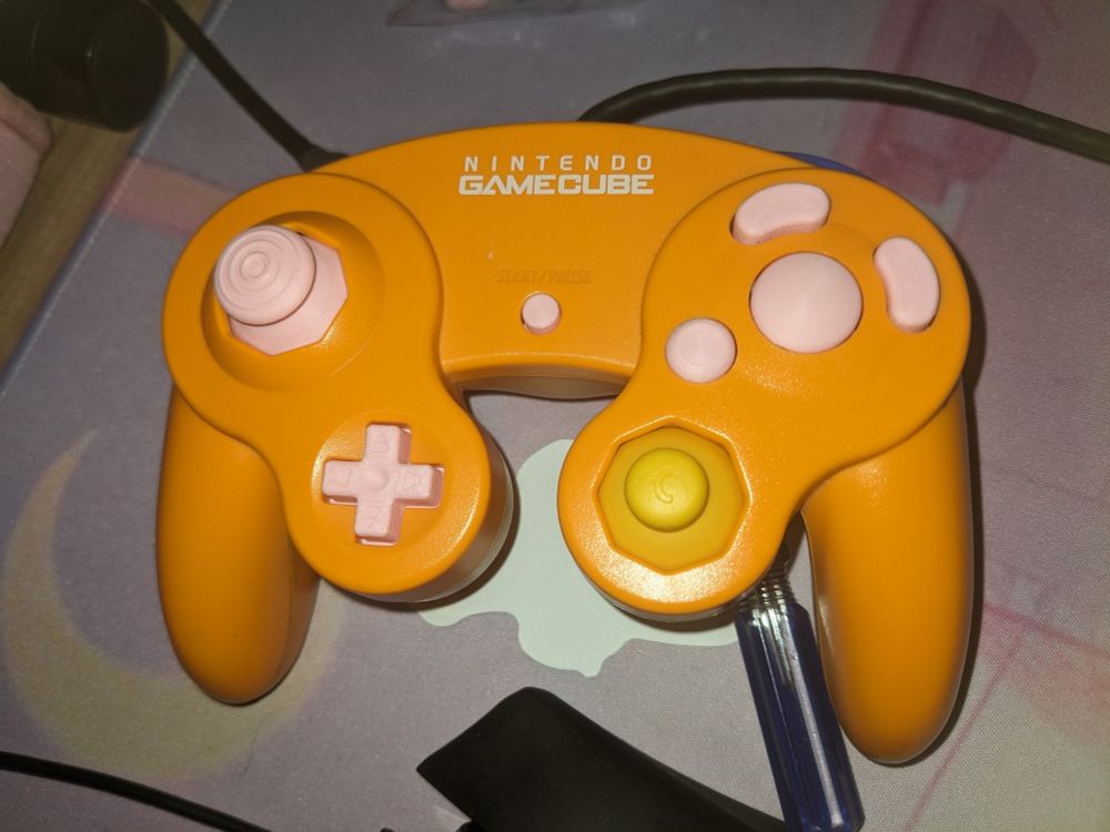 spice orange gamecube controller with pastel pink buttons and control stick