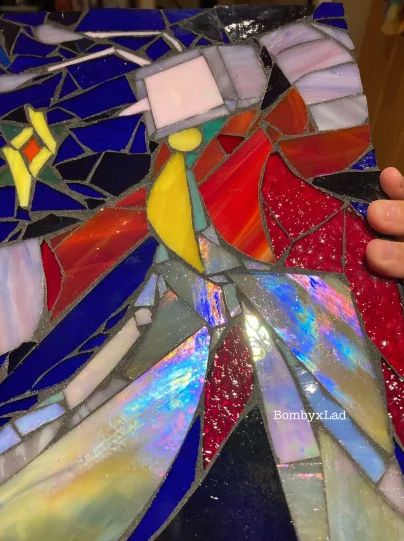 tipped diagonally to show iridescence on his pants