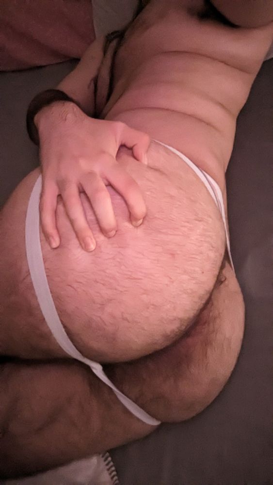 ass pic while laying in bed wearing only a white jockstrap. grabbing my butt with my hand