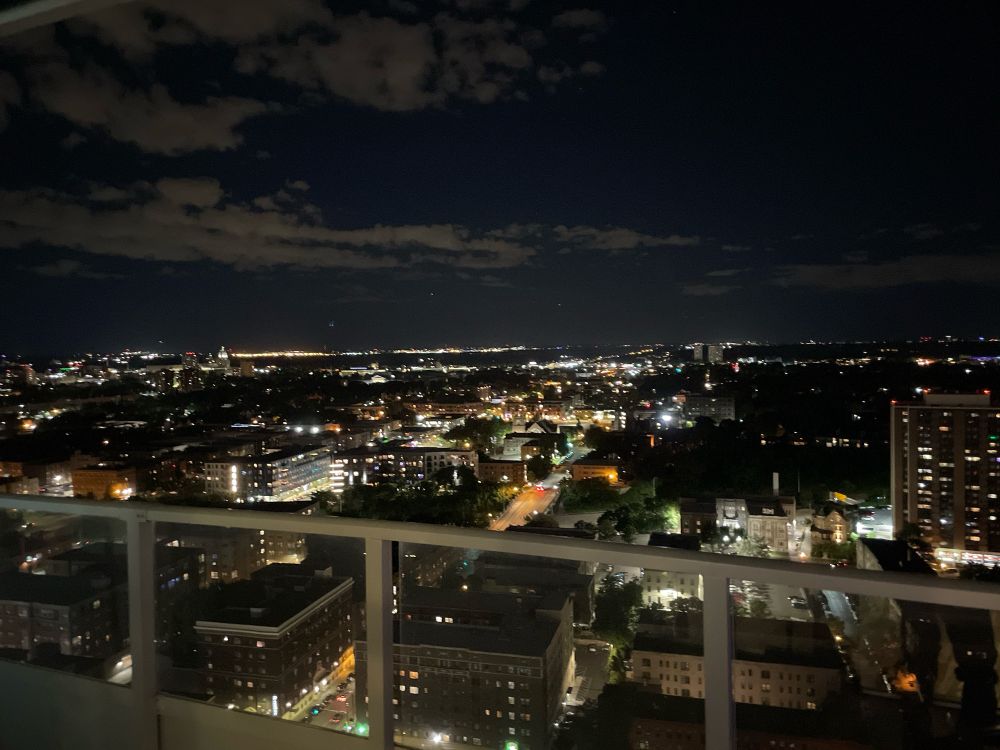 a partial view of downtown minneapolis from the balcony of a very tall building
