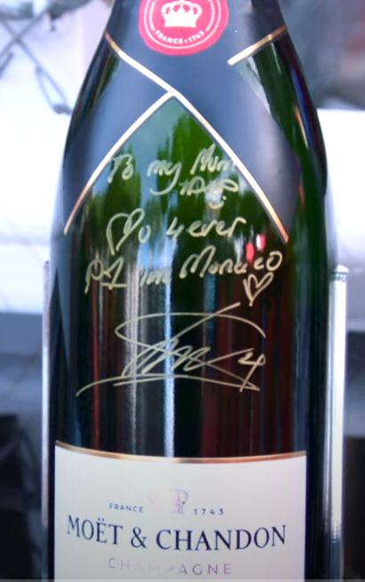 Picture of a champagne bottle after the Monaco Grand Prix 2025. Signed by Lando Norris, the race winner, it says, "To my mom and dad <3 u 4ever P1 in Monaco <3 Lando 4"