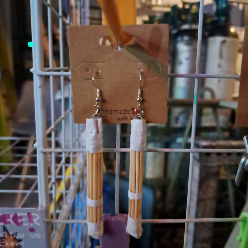 A set of earrings that look like kendo sticks from pro wrestling