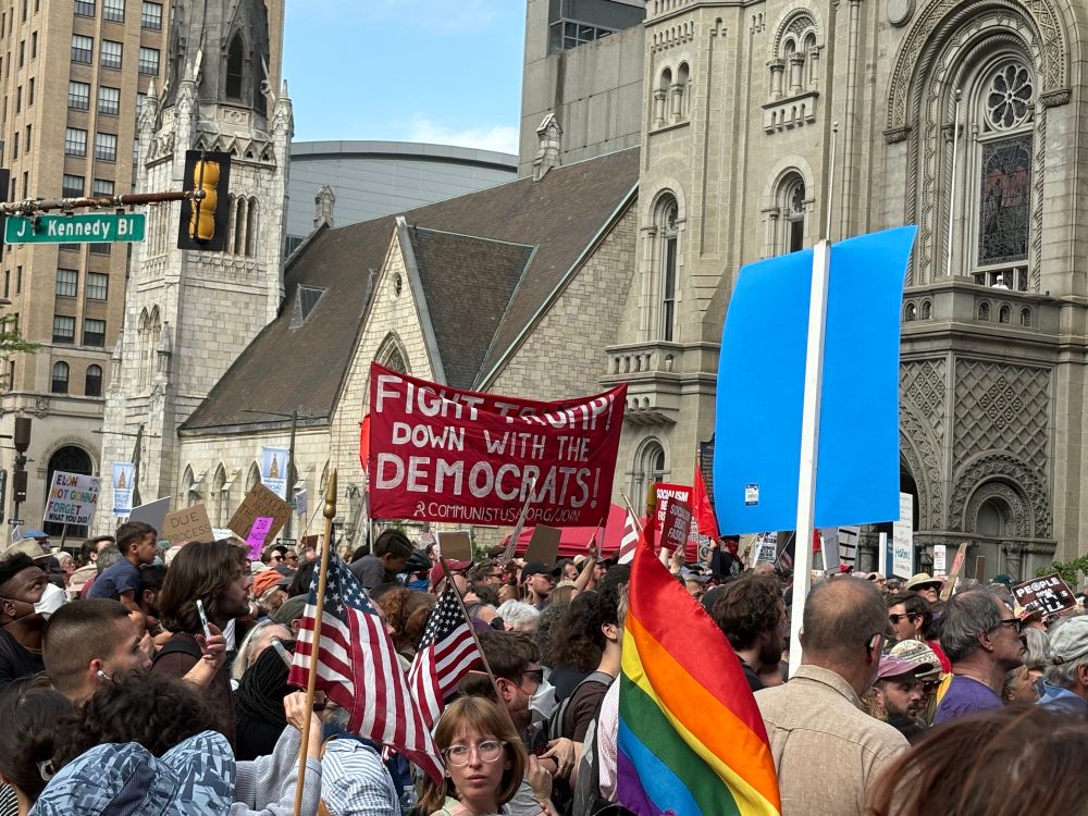 Signs and crowd outside Philadelphia city hall. 