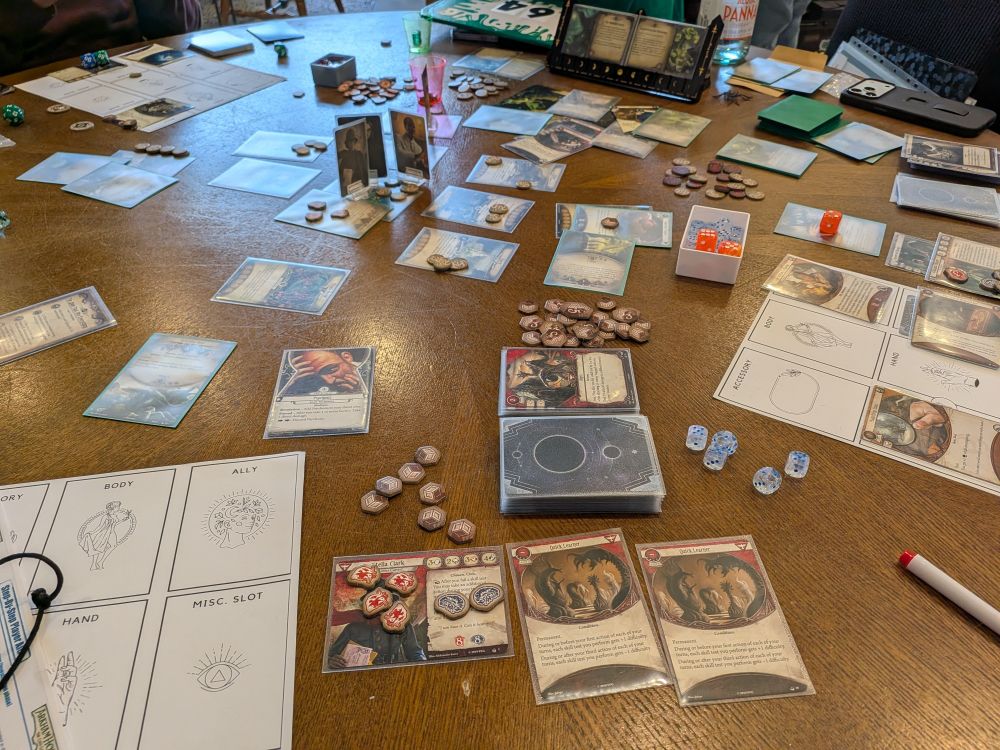 The remains of an Arkham Horror LCG game. The players are being consumed by a blob. 