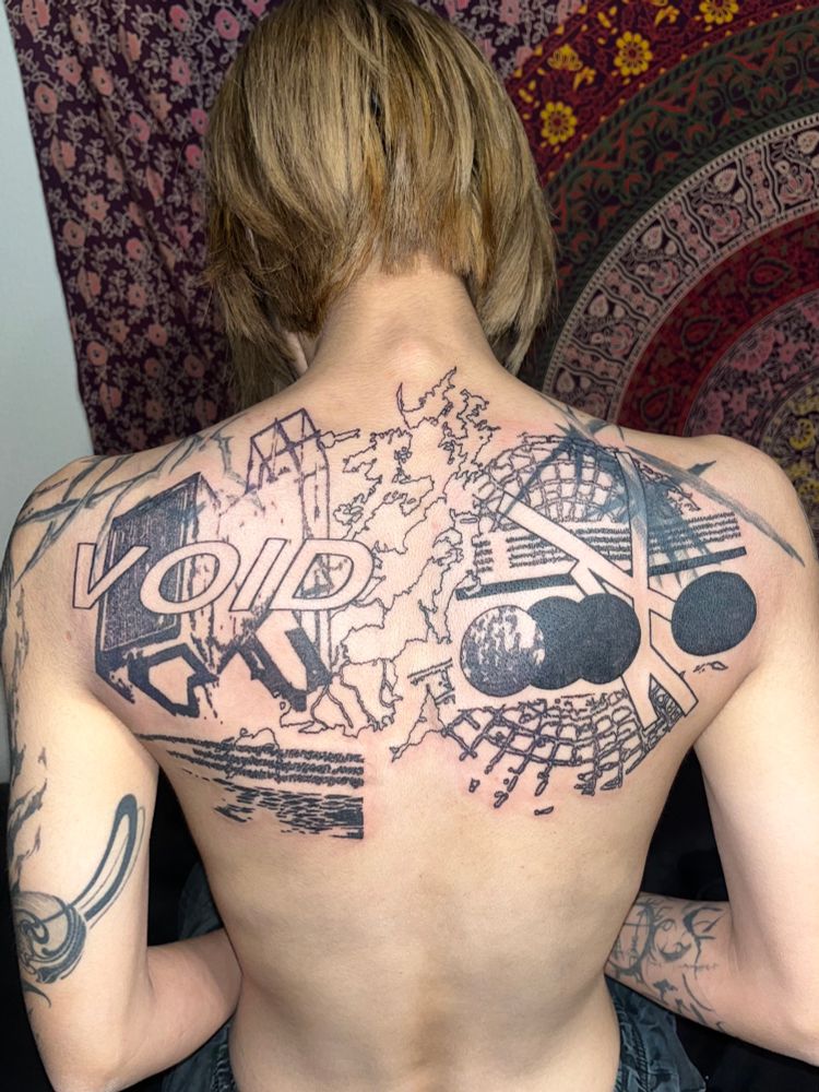 back tattoo of a collage of overlapping abstract shapes