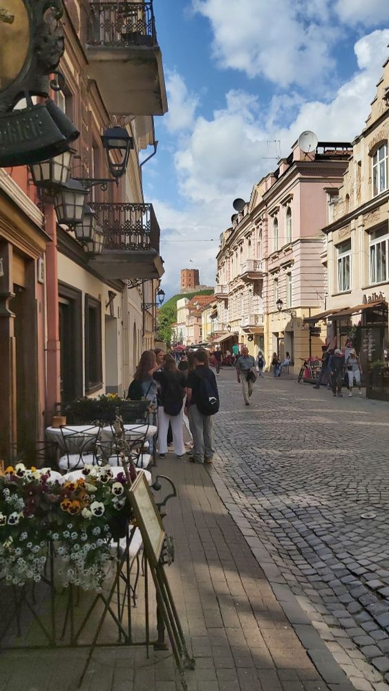 View of a red tower from a pretty cobbled street, Vilnius, Lithuania