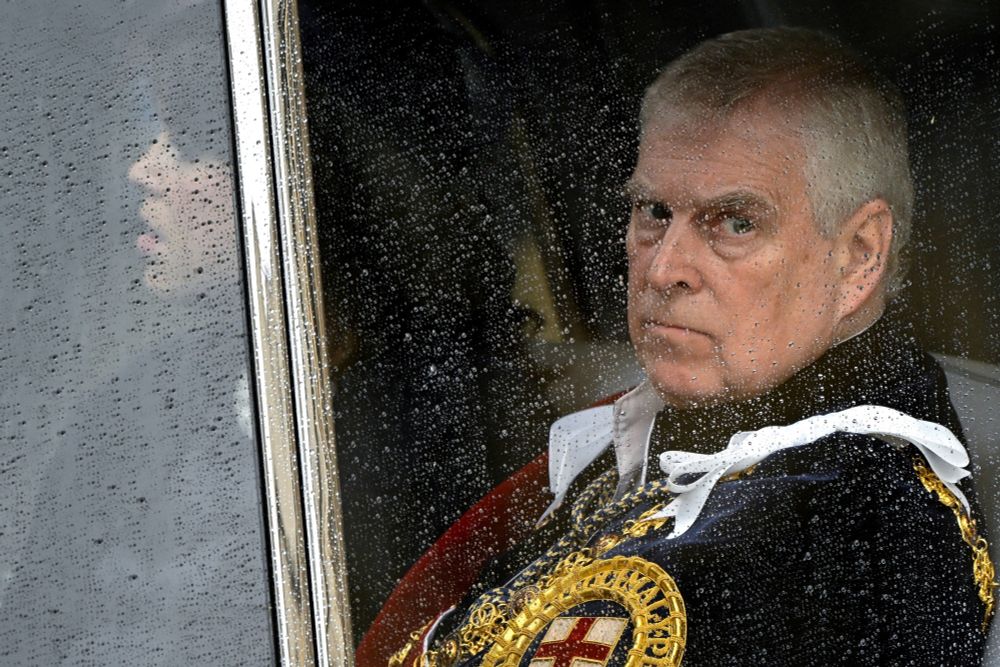 Prine Andrew looking out a rainy window looking very grumpy during the Coronation.