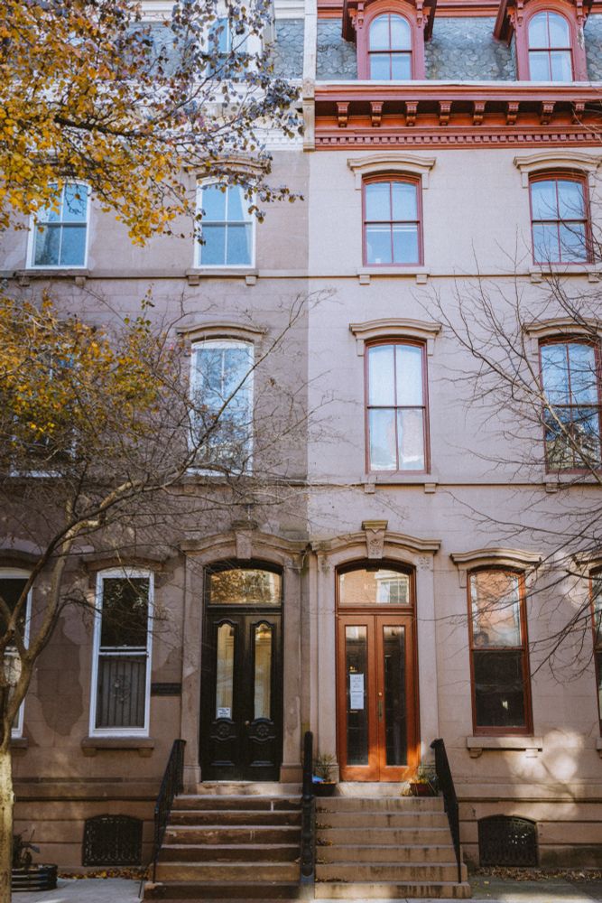 Two connected brownstones splitting the frame 