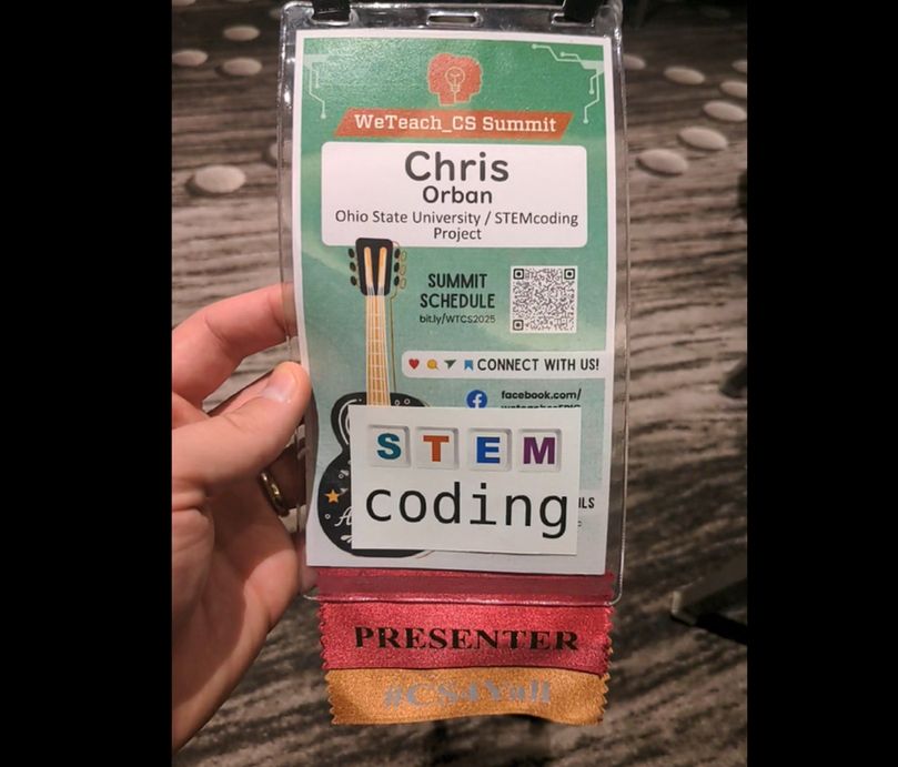 A photo of Chris Orban's conference badge