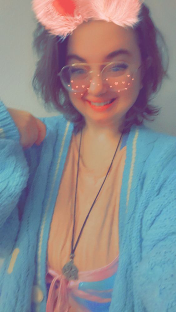 a slightly blurry photo of a girl in a blue and pink outfit