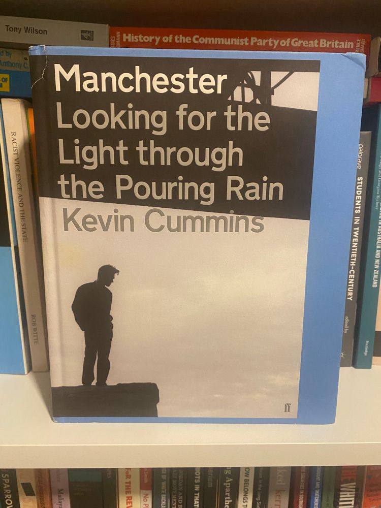 Cover of Manchester: Looking for the Light Through the Pouring Rain by Kevin Cummins, with photograph of silhouetted Morrissey possibly on a rooftop