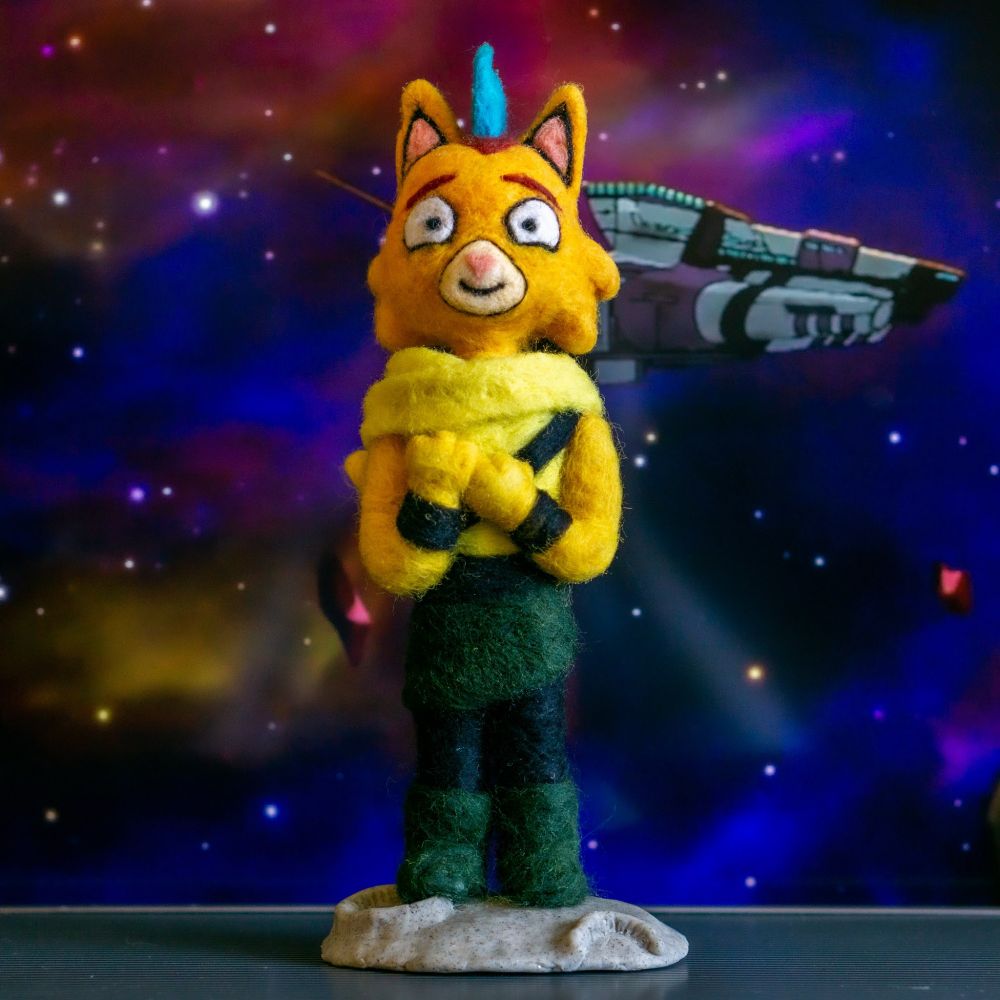 A young needle felted ventraxian, resembling a cat with a turquoise mohican looks lovingly at the camera against a space background 