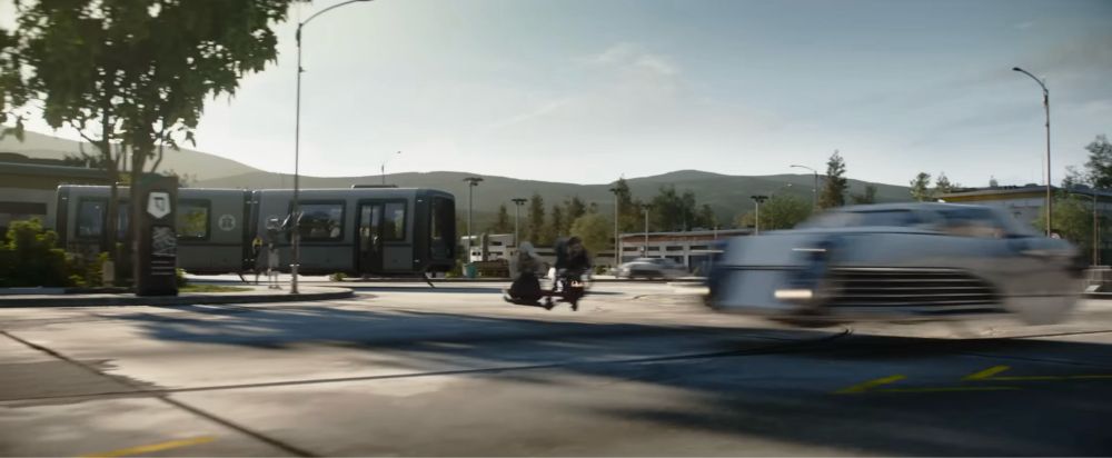 screenshot from the Star Wars: Skeleton Crew trailer showing some vehicles and buildings on an earth-like suburban street