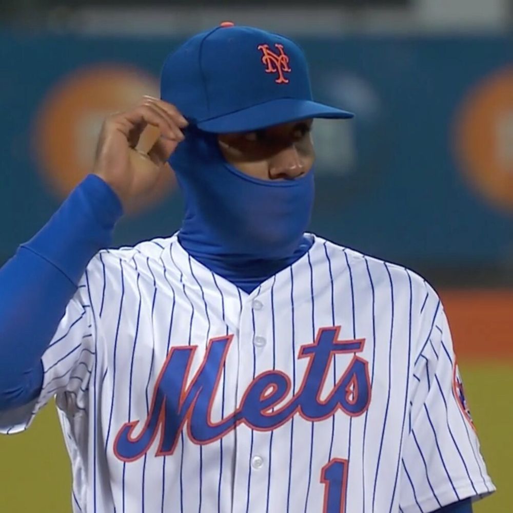 Mets player wearing cold weather gear during a game