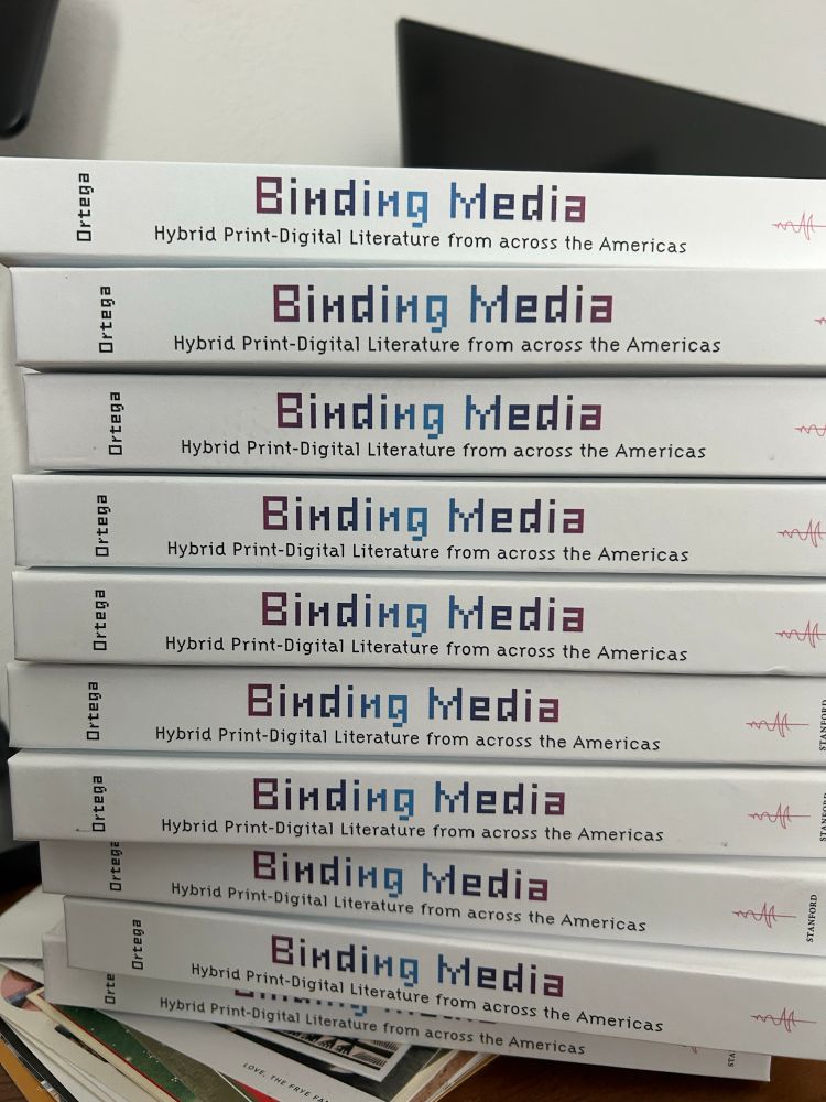 The spines of ten copies of the book. 