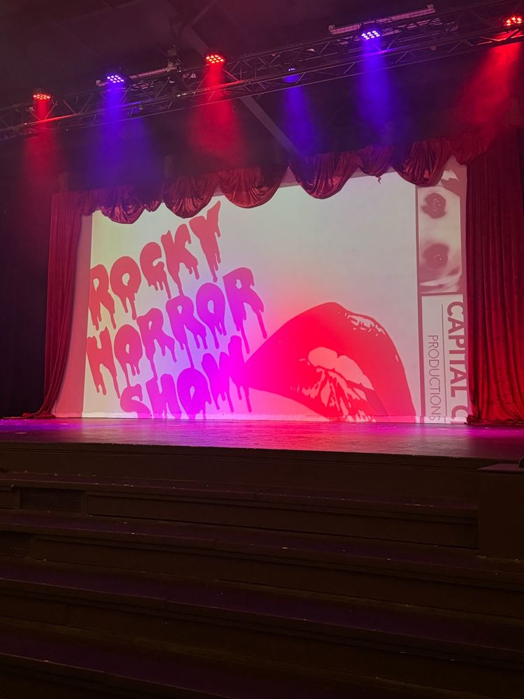 An empty stage with a backdrop for the Rocky Horror Show