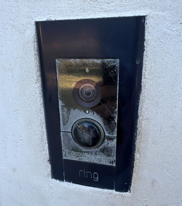 A photo of a Ring video doorbell that was accidentally embedded in concrete.