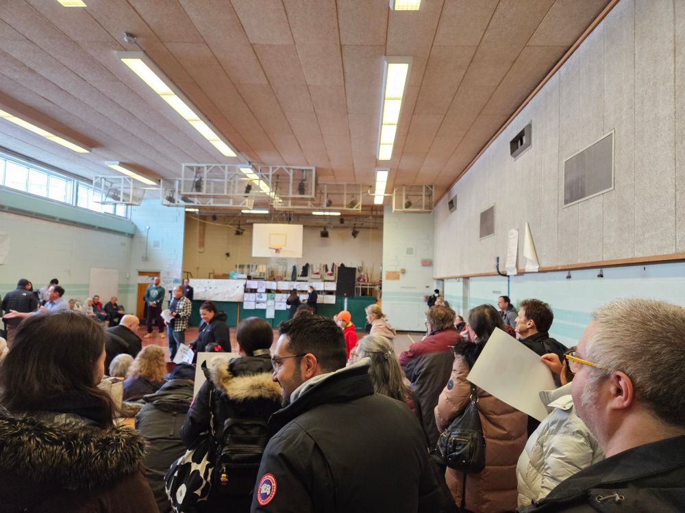 Crowd shot of a number of people in a gymnasium.