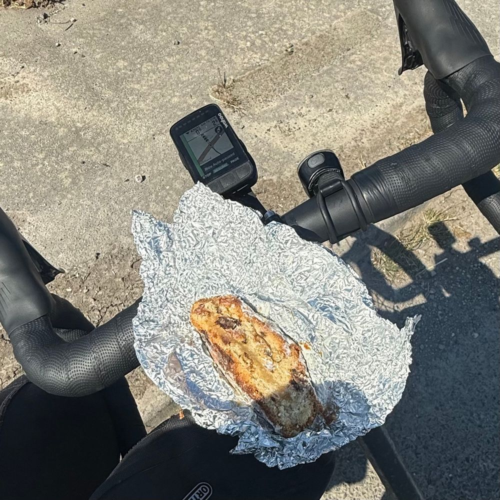 A piece of Stollen left over from Christmas on the handlebars of my bike from a ride this morning.