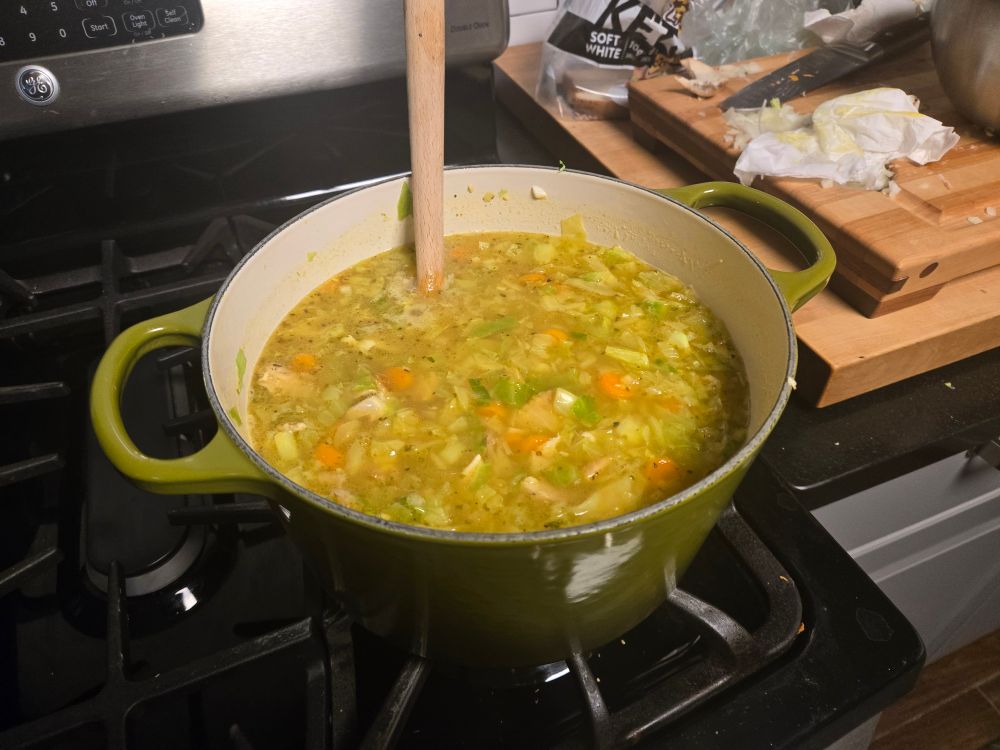 Chicken veggie soup with cabbage, onions, carrots and garlic.