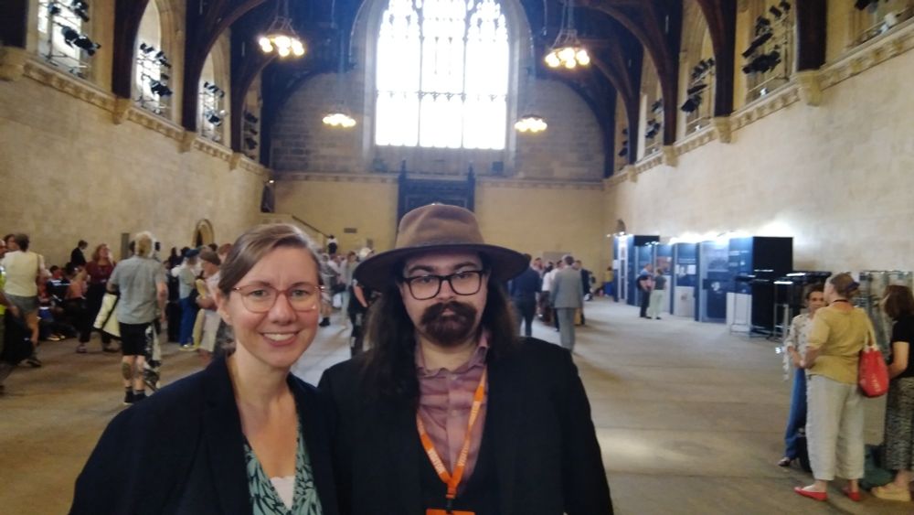 Left - Dr Lauren Sullivan MP. She is a woman, wearing a black jacket, green top & glasses.
Right - Alec Burrett; myself. He is wearing an Australian cowhide hat, glasses, a black jacket and purple shirt.