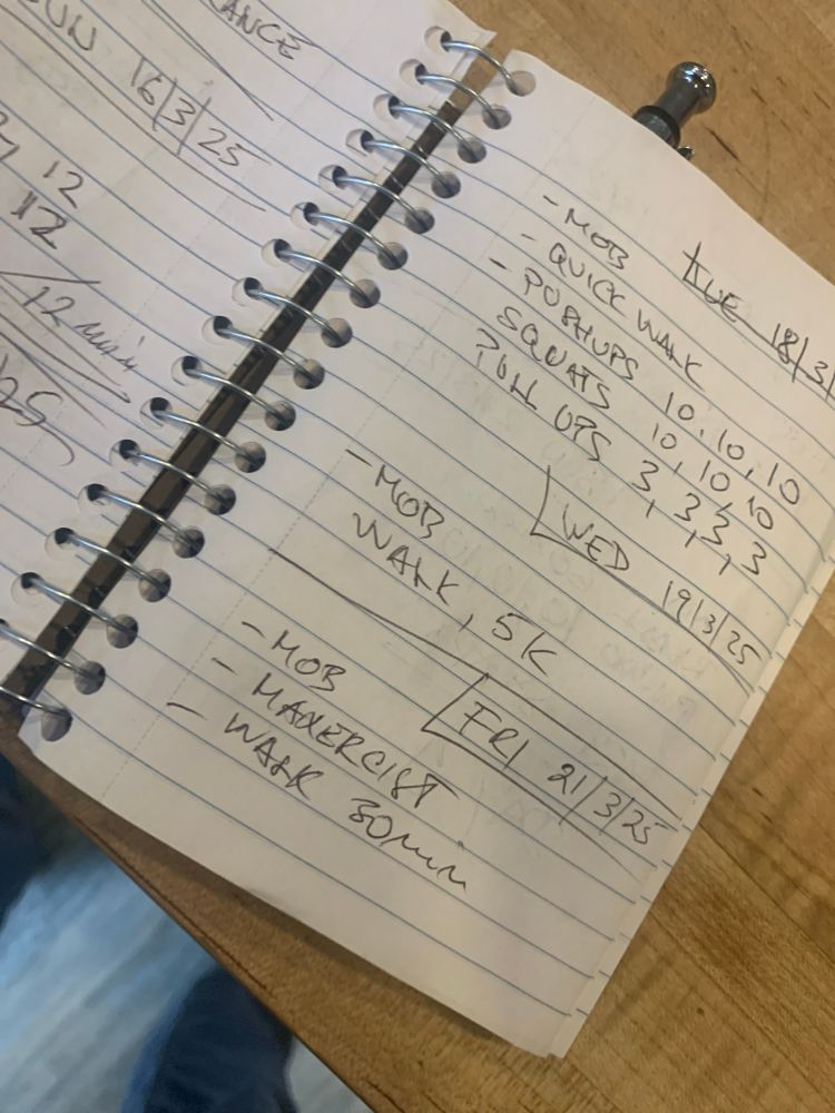 Notebook, with a workout log showing… 