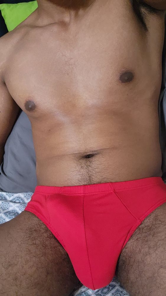 Man in red sports briefs