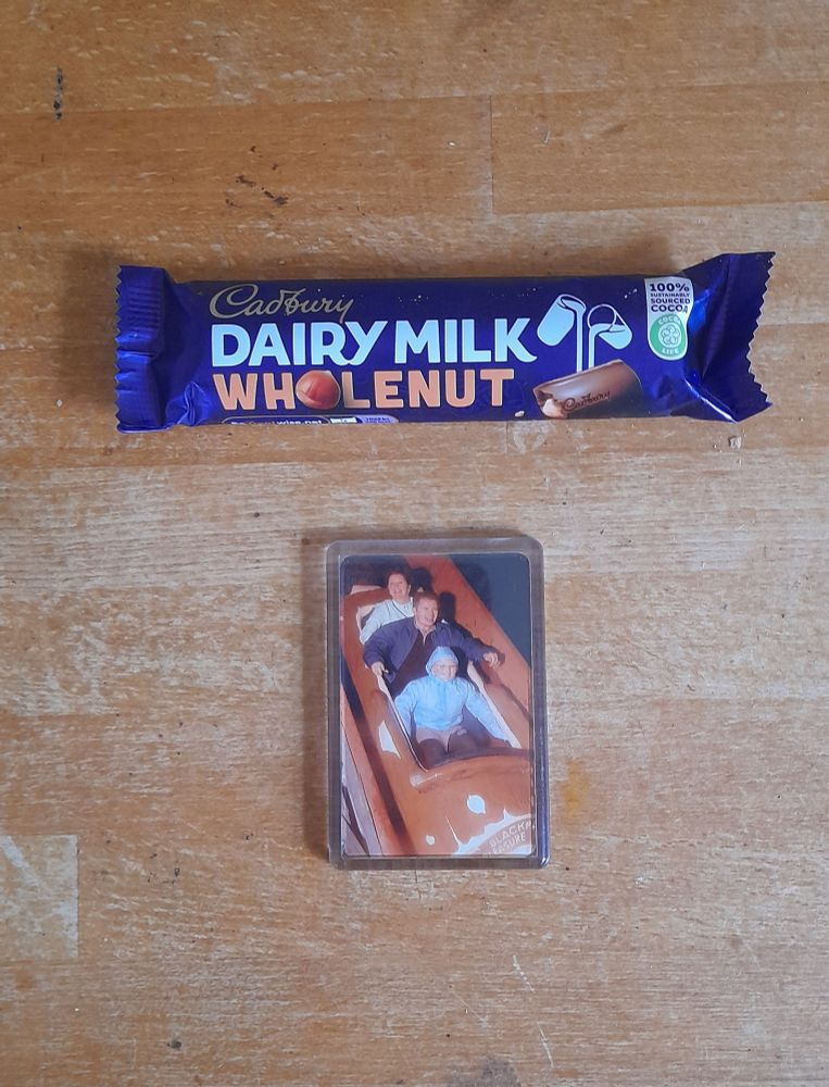 Cadbury Whole Nut standard snack bat next to a photo fridge magnet from the log flume at Blackpool Pleasure Beach.
Pictured: Valerie, me and my niece, Kira 