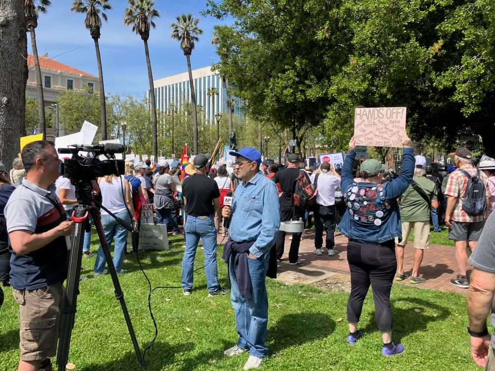 Holding my Hands Off protest sign as the AP reports on San Jose 50501 protest at St James Park