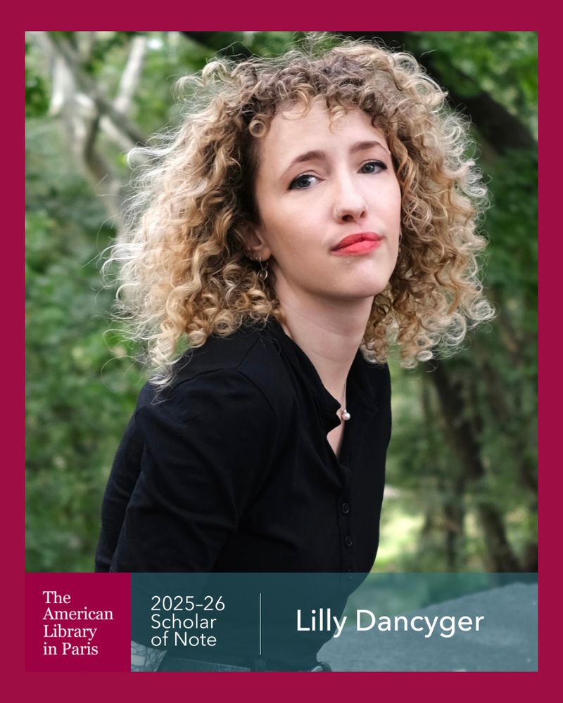 Headshot of Scholar of Note Lilly Dancyger. She is looking at the camera in front of a blurred background of greenery. Her blonde curly hair is down and she is wearing a black top. The bottom of the image has The American Library in Paris logo with the text "2025-26 Scholar of Note Lilly Dancyger"