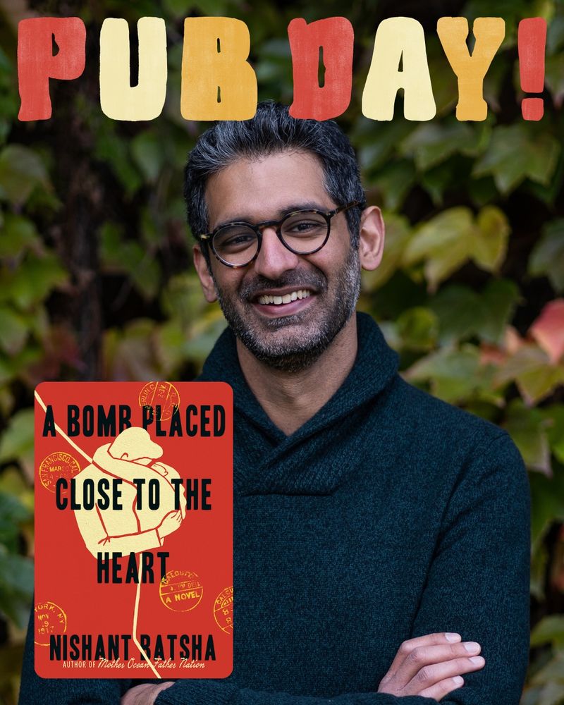 Headshot of writer Nishant Batsha smiling in front of foliage. He is wearing circular glasses and a navy blue long sleeve with his arms crossed in front of him. Above his head, in red, cream, and yellow bubble letters is "PUB DAY!" The cover of his new book, A BOMB PLACED CLOSE TO THE HEART, is in the bottom left corner. The cover has a red background with a cream graphic of a man and woman in an embrace.
