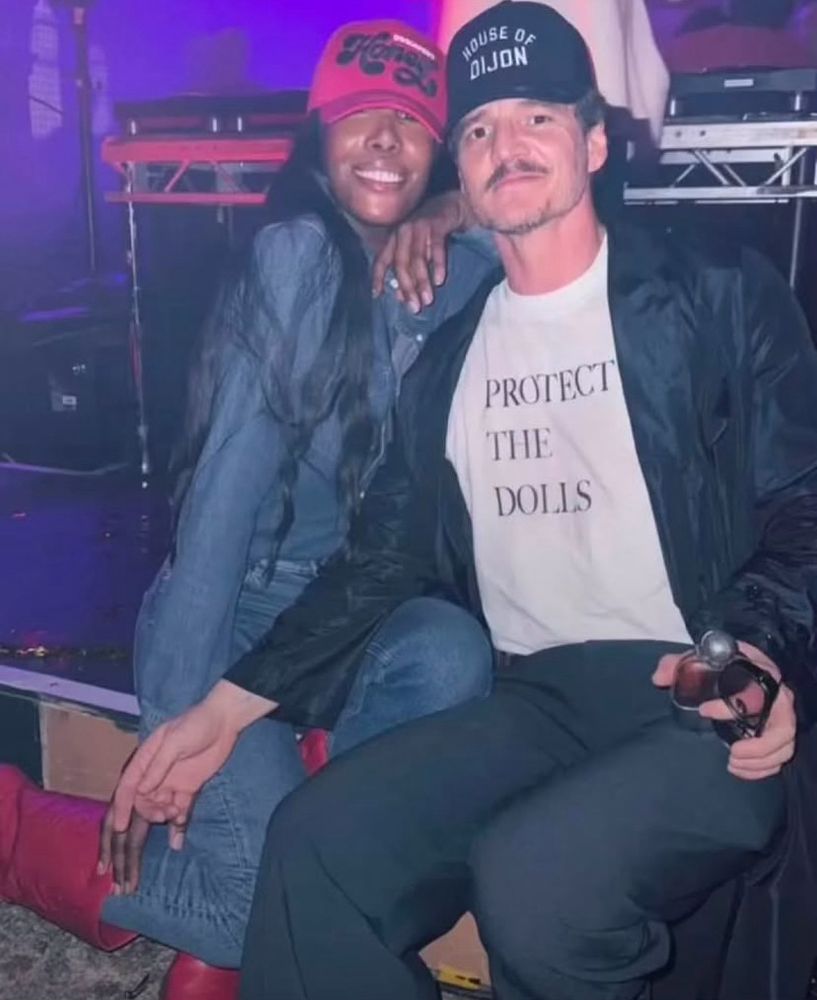 Pedro Pascal, pictured I believe in the house of Dijon wearing a protect the dolls T-shirt.