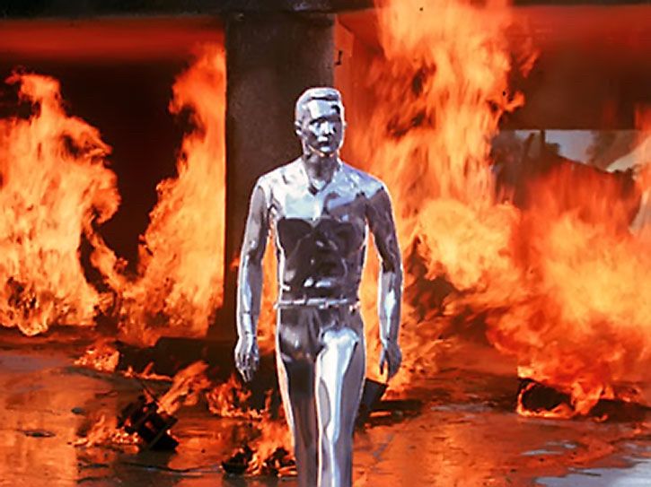 T1000 for terminator 2. Liquid metal cyborg… can shape shift. 
Scene: he is walking out of a fire, all shinny and chrome