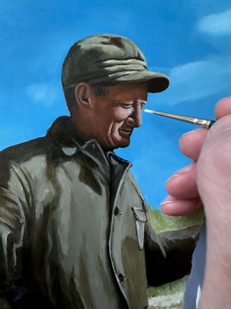 Tight crop of painting a picture of a man dressed in hunting gear.