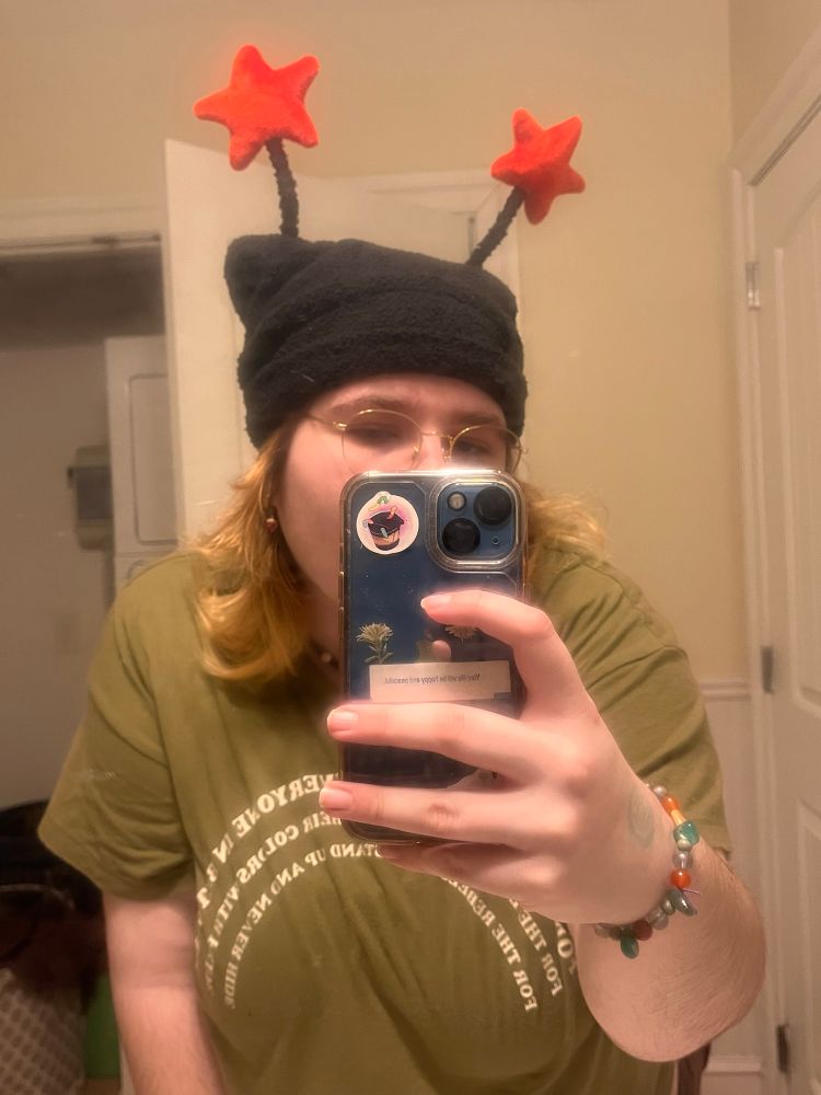 a picture of myself with a black hat and red star antennas in the mirror 

