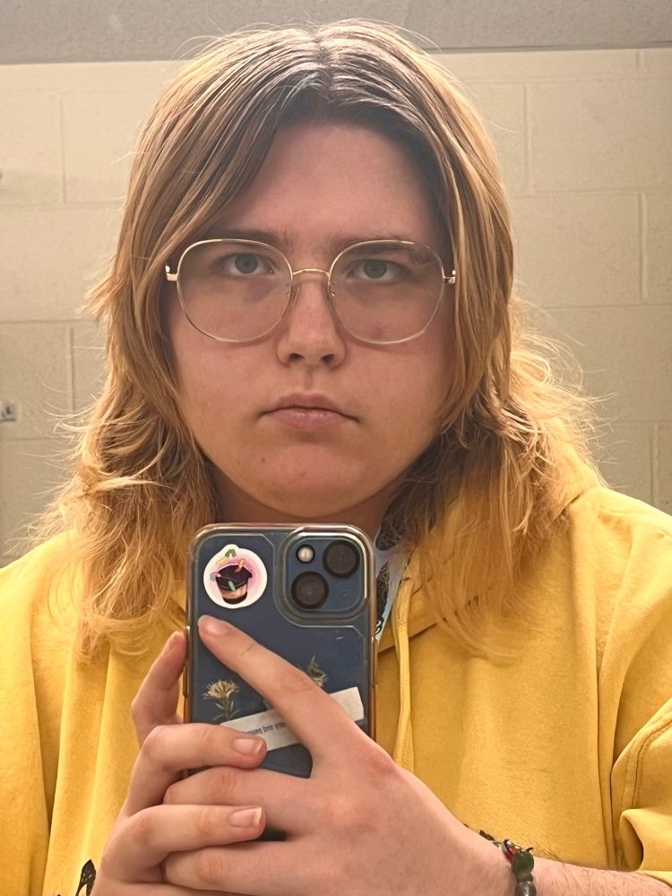 myself looking in the mirror with rounded square glasses
