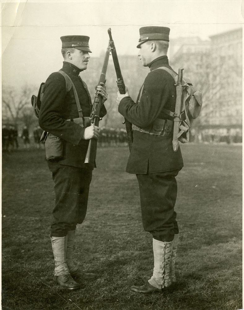 Two Coast Guardsmen conduct a rifle and uniform inspection in New York. (Coast Guard Collection)