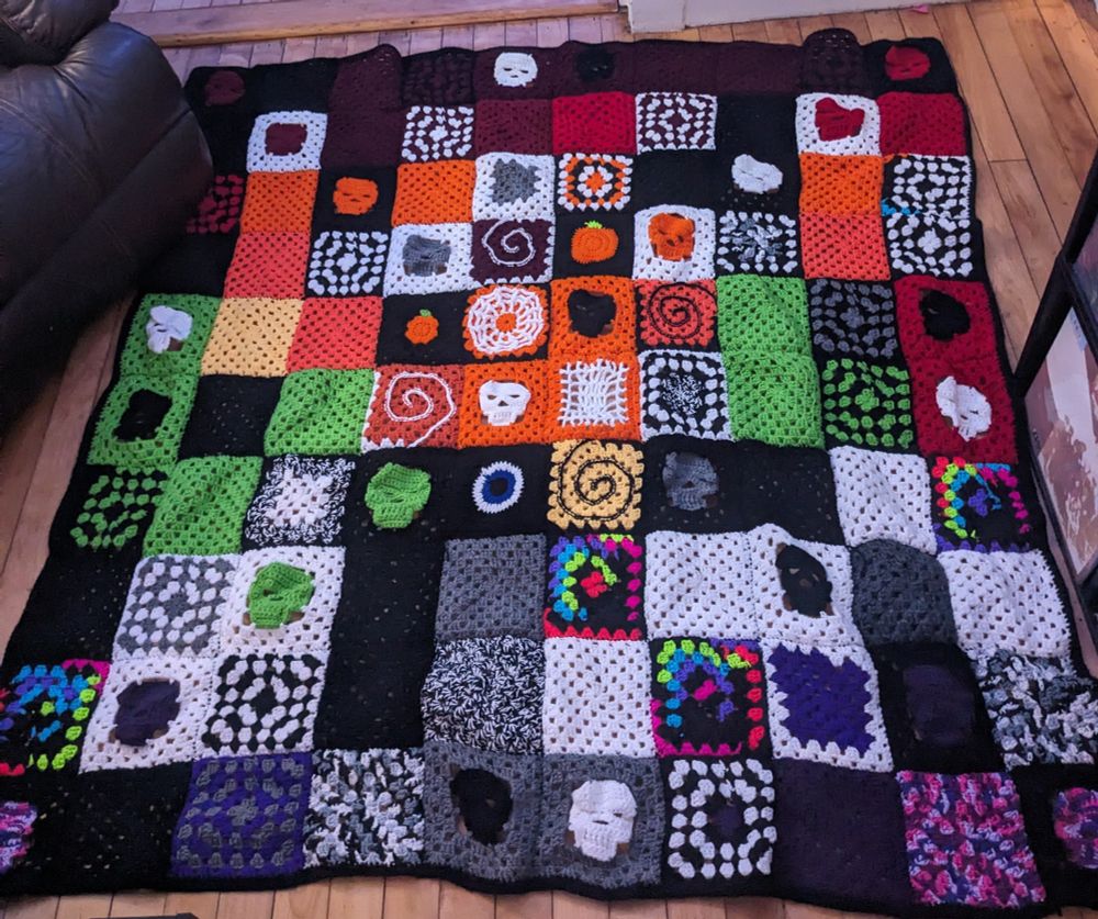 Halloween granny square crochet blanket on the floor
