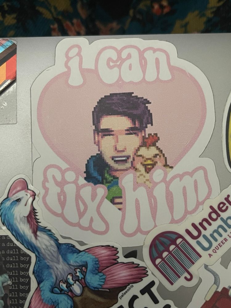 Shane from Stardew Valley in a pink heart with “I can fix him” written around it.  