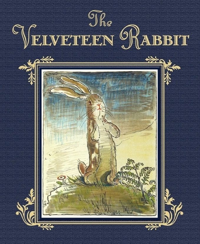 Book cover :  Text The Velveteen Rabbit
Image:  Gold flowing letters on dark blue background.  An illustrated image of a soft toy bunny standing on a a grassy hill.