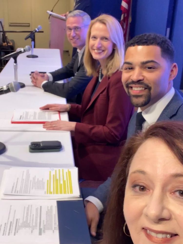 State financial officers talking a selfie on stage. 