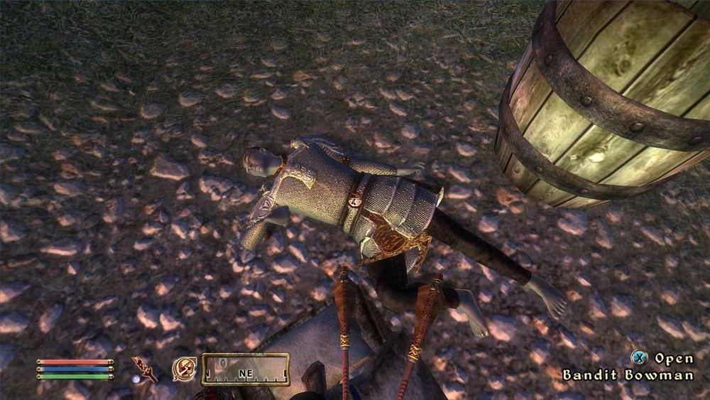 A screenshot of The Elder Scrolls 4: Oblivion, of the player looking at a dead Dark Elf (Dunmer. An elf with dark grey/blue skin) lying dead on the ground. The elf is wearing a Mithril chain mail shirt and sleeves, with some decorative pieces of metal throughout, dark pants, no shoes, and it on the ground next to a barrel. The player is standing on a the pillow end of a bed roll, and has 2 arrows sticking out of their stomach. The outdoor scene is happening at dusk with a faint orange and pink light hitting the rocky dirt and grass in the screenshot.