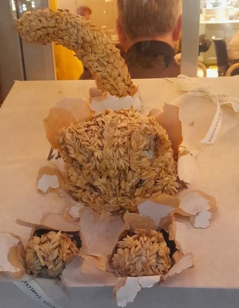 adorable window display from the café Vetekatten (the wheat cat? the cat made from wheat?) in Stockholm. It's a tiny, fierce kitten bursting out of a package. And the kitten is made out of wheat straw. So it's a Vetekattunge (wheat kitten). Foto: Lotta Fjelkegård artist unknown