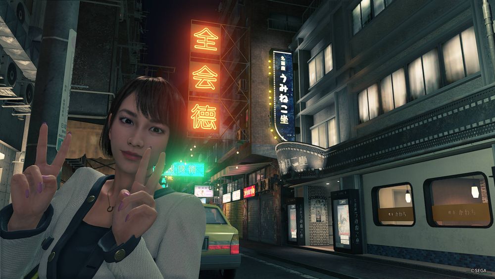 A screenshot from Yakuza: Like A Dragon showing Saeko Mukoda making peace signs with her hands