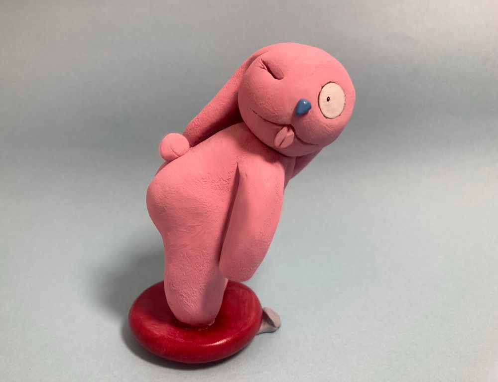 Pink bunny winking at the viewer with their tongue out 