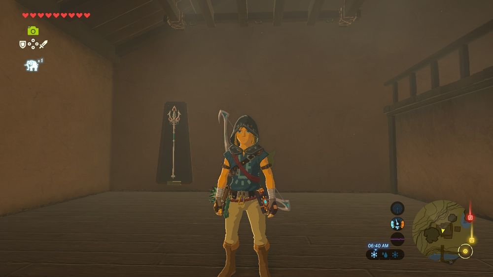 A screenshot from breath of the wild. Link stands in the middle of an empty house, the only thing in it a silver trident mounted on the far wall