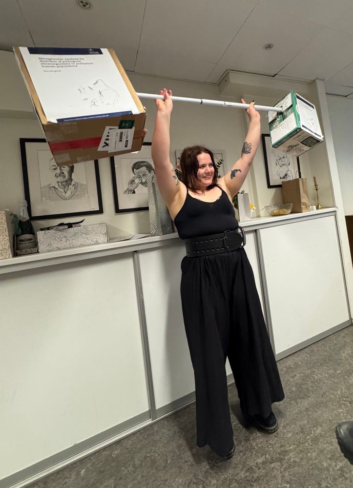 Nora power lifting her PhD thesis (figuratively).