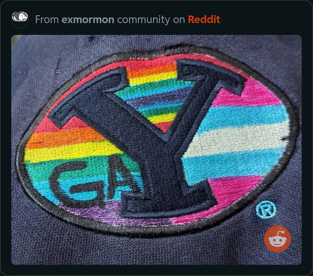 BYU logo painted with rainbow colors and extra letters added to spell out “gay”